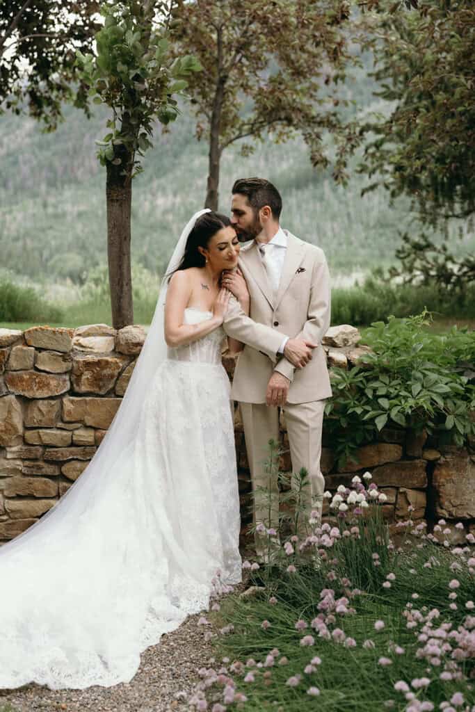 bride and groom share a huge during their luxury Aspen wedding