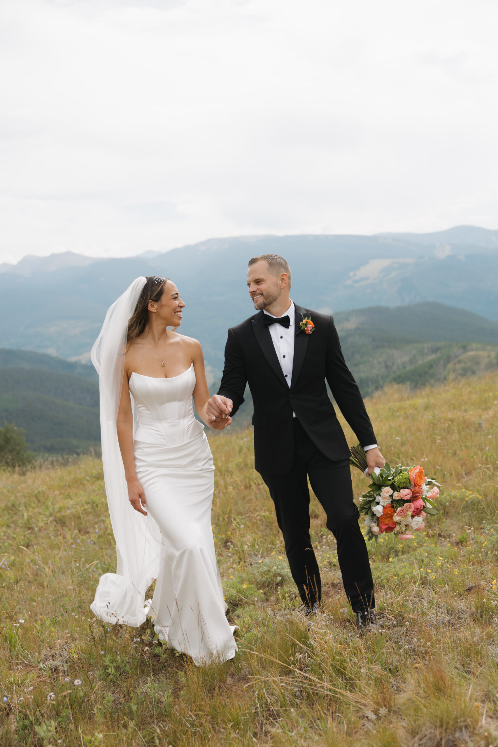 Bride and groom celebrating their marriage at Vail Mountain after their ceremony at The Holy Cross Event Deck